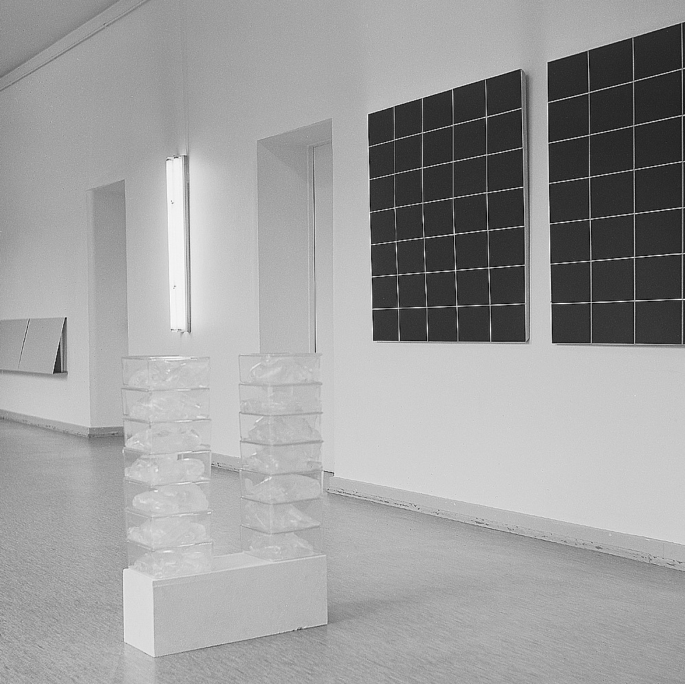 white room with glass blocks stacked in two piles on a pedestal
