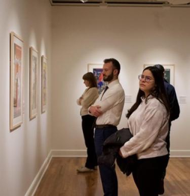 People view an exhibit in the University Art Gallery